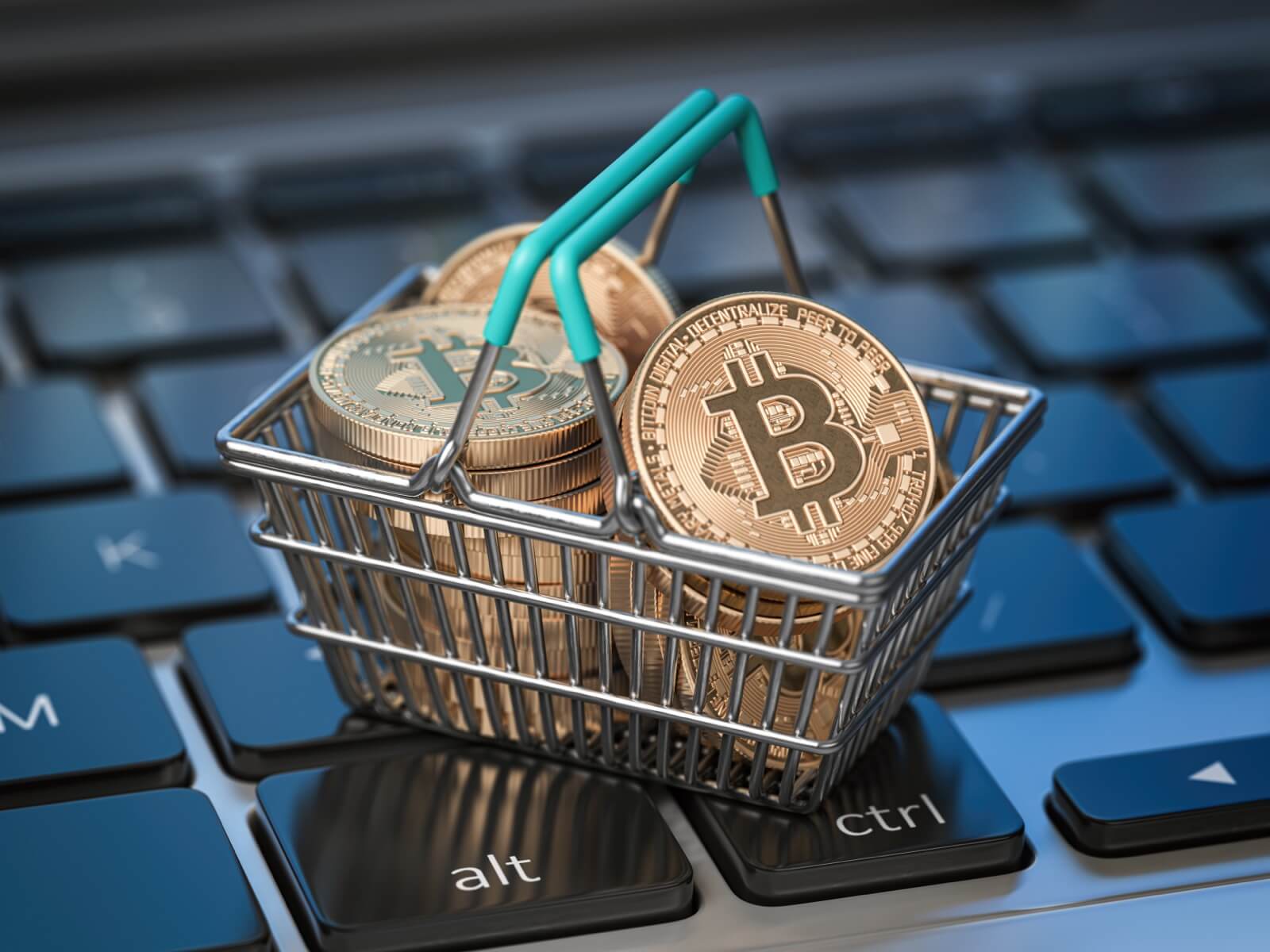 Buying a House With Cryptocurrency - Bitcoin Coins in Shopping Basket on Laptop Keyboard